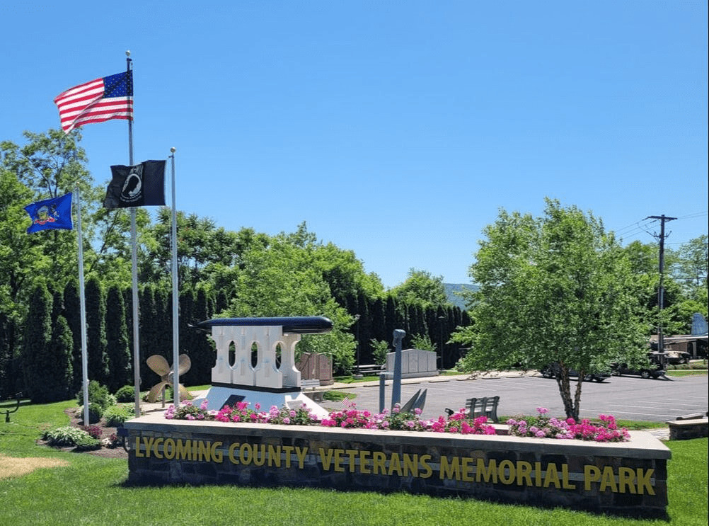 Veterans Memorial Park with flags and monument.
