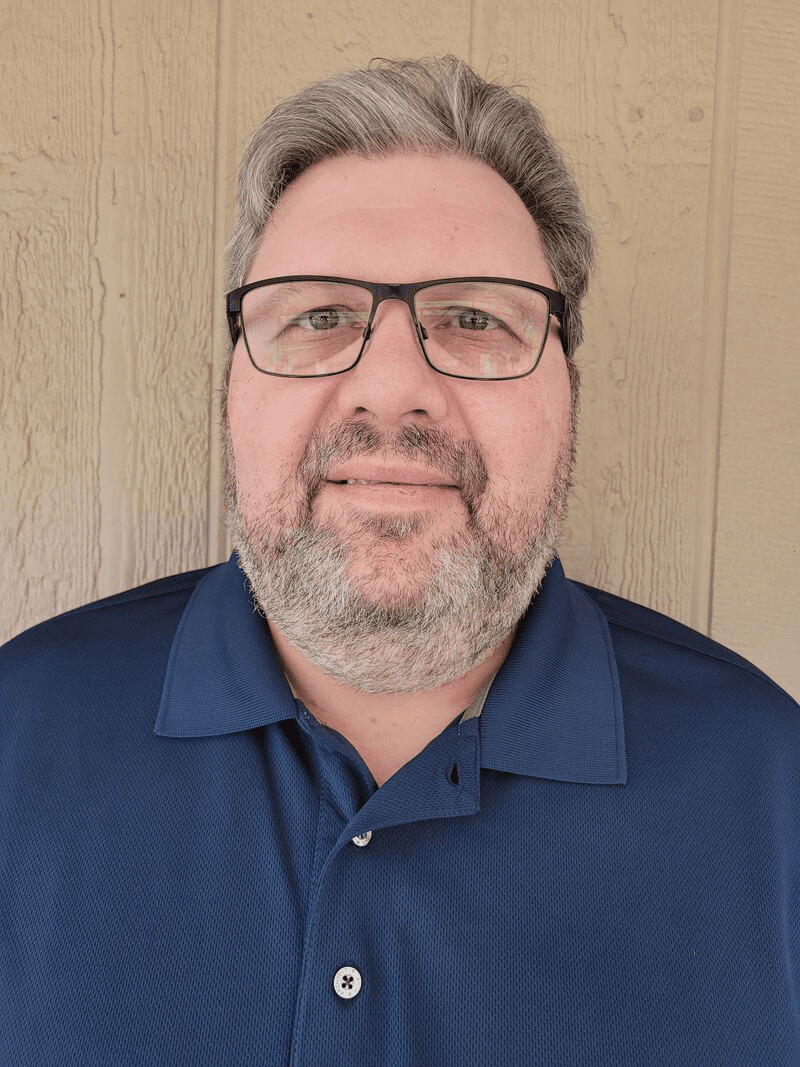 Man with glasses and a blue shirt.